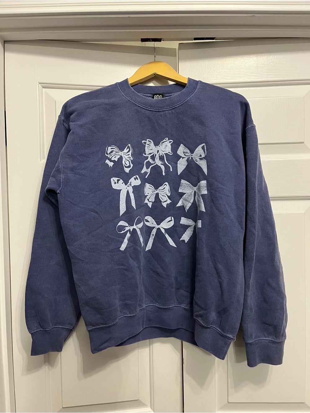 BDG Girl’s Navy Crewneck Sweatshirt with White Bow Graphics